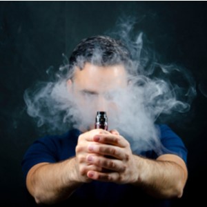 Man Holding a Vape Mod Surrounded by Vapour Man Holding a Vape Mod Surrounded by Vapour