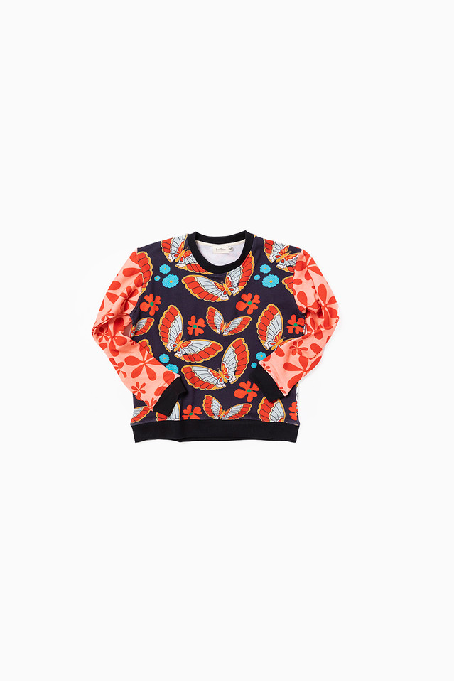 butterfly print sweater laying on white background with contrasting pink and red sleeve.