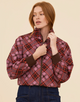 Three-quarter view of a model styling the Renegade Bomber Jacket with the collar turned down, highlighting the comfortable stretch rib cuffs and cozy woven texture.