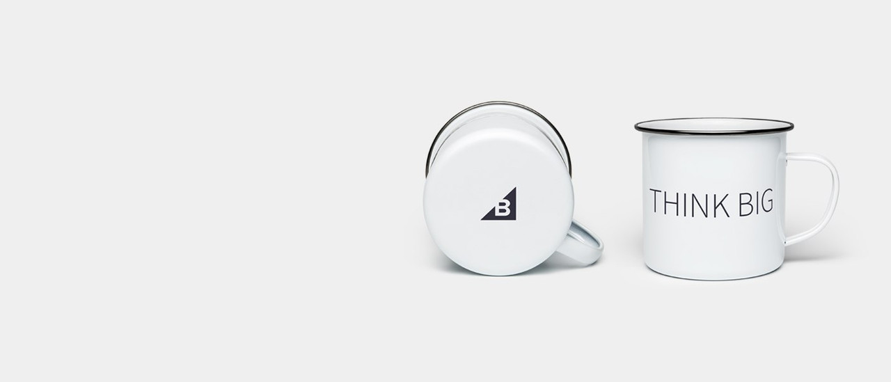 White enamel mug with "Think Big" slogan and BigCommerce logo.