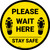 Please Wait Here Stay Safe Shoe Prints Yellow Circular - Floor Sign
