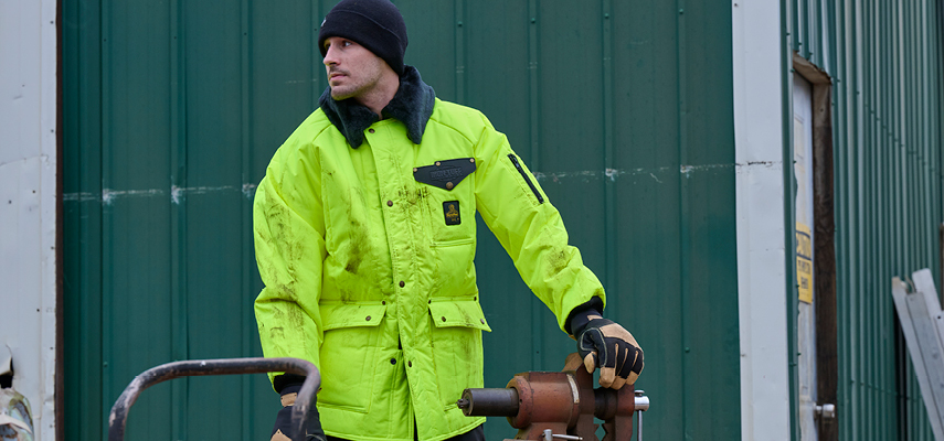 Outdoor worker wearing insulated hivis Iron-Tuff jacket