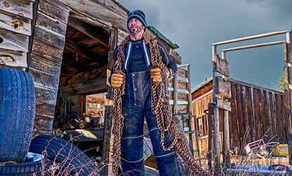 Man working outdoors in the cold carrying ropes