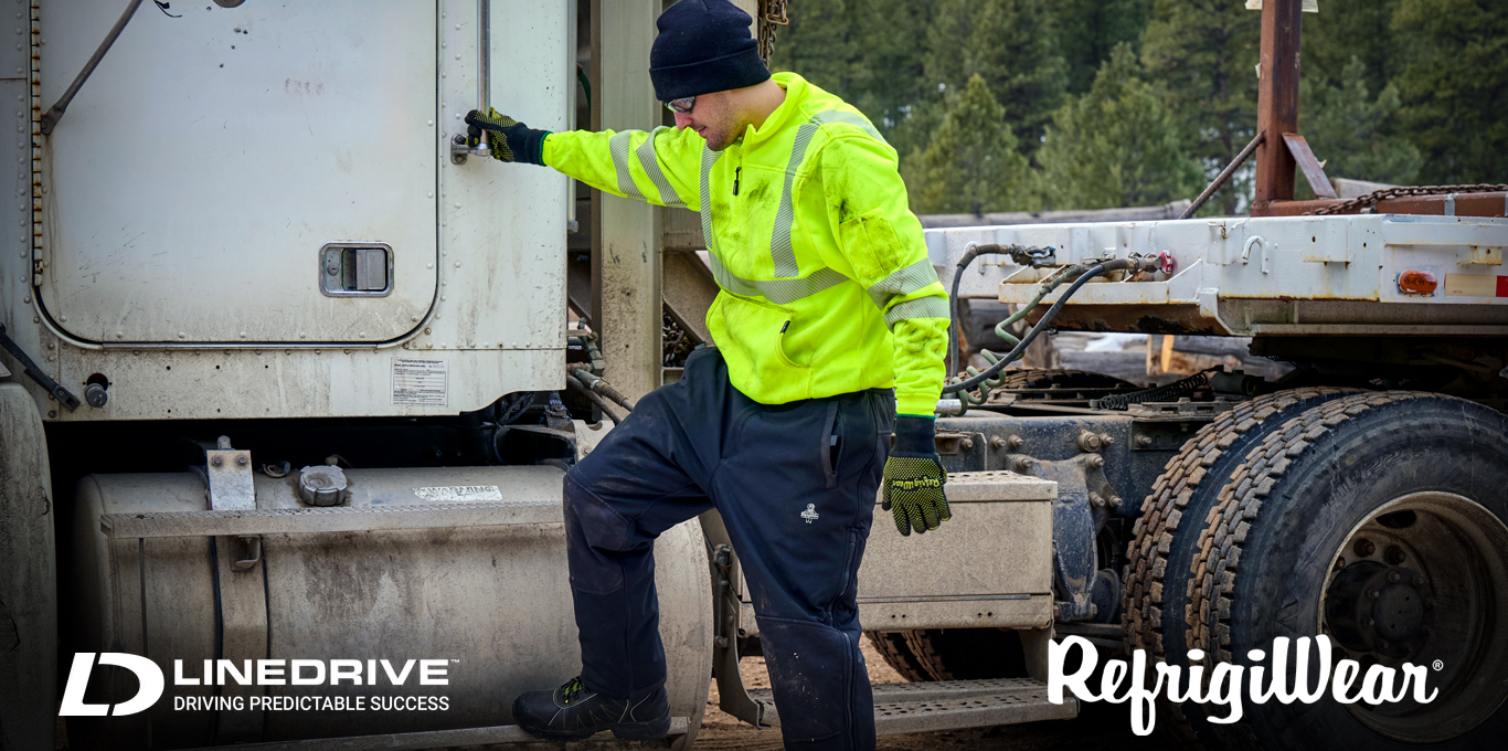 Construction worker on commercial job site wears RefrigiWear high-visibility workwear for protection against cold weather.