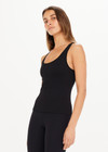 THE UPSIDE women's black, form-fitting Balance Seamless Lenny Tank is made from fabric with moisture control properties and is designed for a soft and supportive fit. This tank top features a scoop neck, cross back straps and shelf bra and bra cups for support.