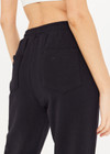 THE UPSIDE women's black Blake Track Pant is a classic, mid rise jogger made from organic cotton french terry. It features elasticated cuffs, an elasticated drawstring waist, side seam pockets and back patch pockets.