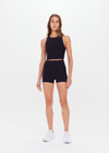 THE UPSIDE women's black Peached 2.5inch Spin Short is a recycled mid-rise spin short in our soft peached fabrication.