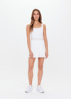 THE UPSIDE womens white scoop neck Peach Lucette panelled mini-dress made with Recycled Peach fabric features a pleated skirt with elastic waistband, built in shorts with pockets, and internal shelf bra.