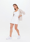 THE UPSIDE womens white scoop neck Peach Lucette panelled mini-dress made with Recycled Peach fabric features a pleated skirt with elastic waistband, built in shorts with pockets, and internal shelf bra.