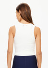 THE UPSIDE women's creme Onyx Kori Crop, made with Recycled Peached fabric is designed for a full coverage fit. This scoop neck top features an internal shelf bra ideal for yoga.