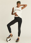 THE UPSIDE women's Jagger 25inch Midi Pant is made from recycled soft peached with moisture wicking, breathable and quick drying properties. The mid rise yoga legging features textured stripe elastic waistband and cuffs.