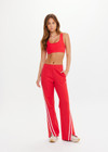 THE UPSIDE women's red Petra Flare Pant is made from a sustainable lenzing viscose material that features a contrast white knitted tape down the sides. This track pant features an elasticated waist and side pockets.