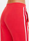 THE UPSIDE women's red Petra Flare Pant is made from a sustainable lenzing viscose material that features a contrast white knitted tape down the sides. This track pant features an elasticated waist and side pockets.
