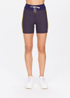 THE UPSIDE women's grey Dunes 5 inch Spin Short is made from recycled textured rib fabrication with moisture wicking properties. The mid-rise spin short are styled with yellow side stripes and drawcord through the waist. Designed for the gym.