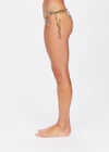 THE UPSIDE women's geo paisley print Vadella Alba Tie Side Pant is made from a soft recycled fabric. The mid coverage bikini bottom feature ties at the sides and metal coated aglets at the tie ends.