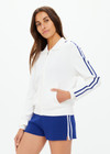THE UPSIDE women's white Carnaby Pari Zip Knit Jacket is a zip through sports jacket with knitted blue stripes down the sleeves and welt pockets. Designed for walking and recovery.