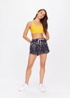 THE UPSIDE women's yellow Dunes Jade Racerback Bra is made from recycled textured rib fabrication with moisture wicking properties. The full coverage bra has a scooped T bar back, internal underbust elastic and removable cups . Designed for the gym.