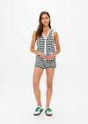 THE UPSIDE women's Portobello Watson Crochet Vest is hand crocheted in a two tone design of green and white. The waistcoat vest features a framed white stripe at the placket, armholes and welt pockets and accessories with white pearlised buttons. Designed for activity golf.