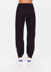 THE UPSIDE women's black Beaufort Cala Zip Pant is made from soft lenzing fabric. The slim fit track pant features contrast white and navy stripe down the sides, elasticated waist and cuffs, invisible zips at cuffs and front and back pockets.