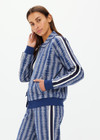 THE UPSIDE women's blue striped Joie Pari Zip Jacket is a jacquard zip through sports jacket, featuring knitted navy and cream stripe tape down sleeves for style and welt pockets and ribbed hem and cuffs for comfort. Designed for leisure and recovery.