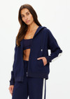 THE UPSIDE women's navy Hamptons Ali Zip up Hoodie is made from a soft suiting lenzing fabrication. The zip through hoodie features welt pockets and drawcord with rubber dipped ends. Designed for leisure and recovery.