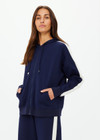 THE UPSIDE women's navy Hamptons Ali Zip up Hoodie is made from a soft suiting lenzing fabrication. The zip through hoodie features welt pockets and drawcord with rubber dipped ends. Designed for leisure and recovery.