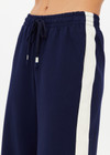 THE UPSIDE women's navy Hamptons Saylor Wide Leg Pant is made from a soft suiting lenzing fabrication. The wide leg pant is fitted with cargo pockets and an elasticated waistband with drawcord. Designed for leisure and recovery.