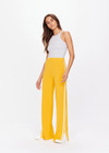 THE UPSIDE women's yellow Dunes Freya Knit Pant is a straight leg pant with an elasticated waistband for comfort and white side stripes. Designed to wear for recovery and leisure.
