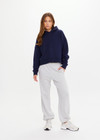 THE UPSIDE women's navy organic cotton Byron Embossed Logo Hoodie is designed for a relaxed boxy fit and features a tonal embossed horseshoe logo on the chest.