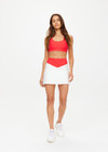 THE UPSIDE women's white Pacific Jaynee Mini Skirt is made from recycled peached. The tennis skirt features built in shorts with pockets. Designed for tennis and pickleball.