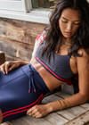 THE UPSIDE women's navy patterned Cavallo Scoop Neck Nina Bra is made from recycled super soft fabric. The sports bra features built in removable cups and adjustable straps. Designed for yoga, pilates and barre.