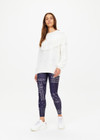 THE UPSIDE women's natural Kansas Tassel Boo Knit Sweater is made from organic cotton. The relaxed crewneck sweatshirt features cable knit design. Designed for lifestyle wear.