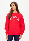 THE UPSIDE women's red Ranchero Saturn Crew Sweater is made from organic cotton. The oversized sweater features print western logo. Designed for lifestyle wear.