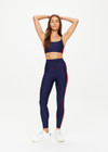 THE UPSIDE women's navy Oxford 25 inch Midi Pant is made from eco tech performance fabric. The gym leggings features red side stripes detailing. Designed for high impact workouts.