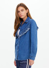 THE UPSIDE women's blue Wildwest Sylve Fringe Shirt is made from organic cotton. The chambray shirt features frayed fringing and pearlised snap buttons. Designed for lifestyle wear.