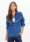 THE UPSIDE women's blue Wildwest Sylve Fringe Shirt is made from organic cotton. The chambray shirt features frayed fringing and pearlised snap buttons. Designed for lifestyle wear.