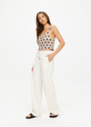 THE UPSIDE women's natural Bow n Arrow Nova Flare Pant is made from jacquard. The wide leg pant features drawstring and patch pocket. Designed for comfort.