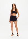 THE UPSIDE women's black Saddle Up Ziggy Short is made from hemp and cotton blend. The gym short features elastic waist and pockets. Designed for comfort.
