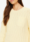 THE UPSIDE women's butter yellow Boo Cable Knit Sweater is made with organic cotton and features a patch pocket at chest and ribbed cuff, neck, and hem.