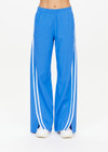 THE UPSIDE women's bright blue Juliet Low Waist Trackpant is made from a slinky, lightweight fabric and feature side stripes, pockets and a split flared hem.