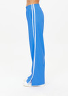 THE UPSIDE women's bright blue Juliet Low Waist Trackpant is made from a slinky, lightweight fabric and feature side stripes, pockets and a split flared hem.