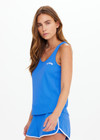 THE UPSIDE women's bright blue Wrangler Issy Racerback Tank Top is made from recycled mesh fabrication and features a curved hem.