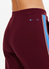 THE UPSIDE women's maroon Ryder Petra Flare Trackpant feature blue side stripes, a split hem, elasticated waist and side pockets.