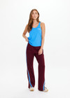 THE UPSIDE women's maroon Ryder Petra Flare Trackpant feature blue side stripes, a split hem, elasticated waist and side pockets.