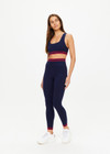 THE UPSIDE women's navy Seamless Jade Racerback Sports Bra is made from soft organic cotton fabric and features a scoop neckline and removable bust cups.
