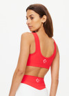 THE UPSIDE women's red Pacific Harley Scoop Neck Bra is made from recycled peached. The supportive sports bra features removable cups. Designed for yoga, pilates and barre.