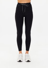 THE UPSIDE women's Peached 25 Inch Pocket legging is a mid rise 7/8 length leg in black with side pockets and a stretch drawcord waistband. The fabric is breathable and quick drying.