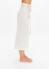 THE UPSIDE women's cream Beach Serenade Wrap Sarong is made from cotton. The beach sarong skirt features vegan leather braided belt. Designed for layering and travel.