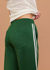 THE UPSIDE women's green When in Roma Holiday Pant is made from recycled fabric. The high waisted side stripe pant features splits at hem. Designed for comfort.