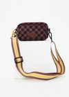 THE UPSIDE women's recycled fabric black and chocolate check Technica Voyage Crossbody Bag features multiple pockets with zippers, plus an adjustable and removable stripe strap.